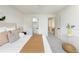 A bright bedroom featuring neutral tones, modern finishes, and a view into the hallway at 11586 Chase Way, Westminster, CO 80020