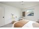Bright bedroom with a clean modern aesthetic, neutral tones, and natural light from the window at 11586 Chase Way, Westminster, CO 80020