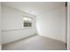 Vacant room with neutral paint and carpet, featuring a window for natural light at 11586 Chase Way, Westminster, CO 80020