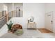 Bright entryway with modern railings, neutral decor, and a stylish seating area at 11586 Chase Way, Westminster, CO 80020