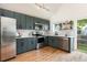 Modern kitchen with stainless steel appliances, sleek cabinetry, and butcher block countertops at 11586 Chase Way, Westminster, CO 80020