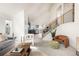 Bright living room featuring vaulted ceilings, modern furnishings, and staircase to the upper level at 11586 Chase Way, Westminster, CO 80020