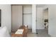 Home office with neutral decor and a view to the hallway, featuring a desk and sliding closet doors at 11586 Chase Way, Westminster, CO 80020