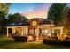 Inviting backyard featuring a hot tub, outdoor kitchen with bar, and charming pergola for entertaining on a lush lawn at 2 University Ln, Greenwood Village, CO 80121
