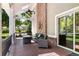 Charming covered porch with brick fireplace and outdoor seating, perfect for relaxing and entertaining guests at 2 University Ln, Greenwood Village, CO 80121
