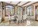Dining room features stone walls, beamed ceilings and large windows that let in natural light at 2 University Ln, Greenwood Village, CO 80121