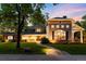 Charming home featuring a stone pathway, manicured lawn, and a blend of stone and siding exterior details at 2 University Ln, Greenwood Village, CO 80121