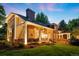 Beautiful home exterior with stone accents, covered porch, manicured lawn and mature landscaping at 2 University Ln, Greenwood Village, CO 80121