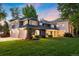 Charming home with a large manicured lawn, beautiful landscaping, and a three car garage at 2 University Ln, Greenwood Village, CO 80121