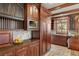 Kitchen features wood cabinets, stone floors and countertops, and stainless steel microwave at 2 University Ln, Greenwood Village, CO 80121