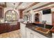 Kitchen features stone floors, stainless steel sink, wood cabinets, and stone accents at 2 University Ln, Greenwood Village, CO 80121