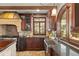Kitchen boasts wood cabinets, stone floors and backsplash, and stainless steel sink at 2 University Ln, Greenwood Village, CO 80121