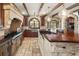 Kitchen features stone floors, stainless steel appliances, wood cabinets and beamed ceiling at 2 University Ln, Greenwood Village, CO 80121