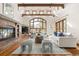 Spacious living room with hardwood floors, a brick fireplace, large window, and stylish furniture at 2 University Ln, Greenwood Village, CO 80121