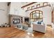 Elegant living room featuring hardwood floors, a fireplace, and large windows at 2 University Ln, Greenwood Village, CO 80121
