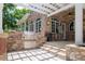 Beautiful outdoor kitchen with built-in grill, counter seating, and stone features under a pergola at 2 University Ln, Greenwood Village, CO 80121