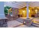 Outdoor kitchen and patio area featuring a built-in grill, brick accents, and a covered pergola at 2 University Ln, Greenwood Village, CO 80121