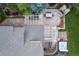 An elegant outdoor space with a flagstone patio, fireplace, hot tub, and outdoor dining area at 2 University Ln, Greenwood Village, CO 80121