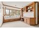Cozy sitting room with built-in shelving, bench seating, natural light, and plenty of storage at 2 University Ln, Greenwood Village, CO 80121