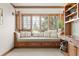 Cozy sitting room boasts built-in shelving, bench seating, natural light, and lots of character at 2 University Ln, Greenwood Village, CO 80121