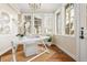 Bright sun room features hardwood floors, decorative chandelier, bright windows, and beadboard walls at 2 University Ln, Greenwood Village, CO 80121