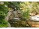 Serene water feature surrounded by lush greenery creating a peaceful outdoor oasis at 2 University Ln, Greenwood Village, CO 80121