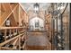 Elegant wine cellar with custom wood racking, brick accents, and wrought iron door at 2 University Ln, Greenwood Village, CO 80121
