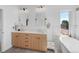 Bright bathroom with double vanity, quartz countertop, and soaking tub near the window at 2501 Vrain St, Denver, CO 80212