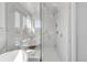 Bright bathroom featuring a glass enclosed shower, soaking tub, and marble finishes at 2501 Vrain St, Denver, CO 80212
