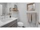 Modern bathroom featuring a gray vanity, white countertops, and stylish mirror and towel decor at 2501 Vrain St, Denver, CO 80212
