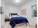 Cozy bedroom featuring a comfortable bed with blue bedding and natural light from the window at 2501 Vrain St, Denver, CO 80212