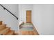 Bright entryway featuring hardwood floors, a sleek staircase, and a modern front door at 2501 Vrain St, Denver, CO 80212