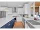 Bright kitchen featuring stainless steel appliances, white cabinetry, and a center island with blue cabinets at 2501 Vrain St, Denver, CO 80212