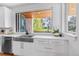 Bright kitchen with stainless steel appliances, white countertops, and a farmhouse sink at 2501 Vrain St, Denver, CO 80212
