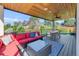 Cozy outdoor deck with cushioned seating, an outdoor table, and a view of the landscaped yard at 2501 Vrain St, Denver, CO 80212