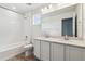 Bright bathroom features a double sink vanity, shower, tub, and wood-look floors at 19080 E 96Th Pl, Commerce City, CO 80022
