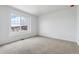 This bright bedroom features a large window and carpeted floors at 19080 E 96Th Pl, Commerce City, CO 80022