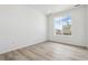 Bright, minimalist bedroom with large window and modern light wood flooring at 19080 E 96Th Pl, Commerce City, CO 80022