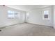 This bedroom features large windows and carpeted floors at 19080 E 96Th Pl, Commerce City, CO 80022