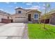 Charming two-story home showcasing a well-manicured lawn and a spacious two-car garage at 19080 E 96Th Pl, Commerce City, CO 80022