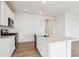 Kitchen featuring white cabinets, stainless steel appliances, and a functional center island at 19080 E 96Th Pl, Commerce City, CO 80022