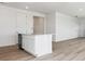 Well-lit kitchen featuring a functional island, ample storage, and wood-look flooring at 19080 E 96Th Pl, Commerce City, CO 80022