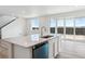 Kitchen island with quartz countertops, stainless steel sink and modern dishwasher at 19080 E 96Th Pl, Commerce City, CO 80022