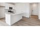 Bright kitchen with an island, stainless steel appliances, and ample cabinet space at 19080 E 96Th Pl, Commerce City, CO 80022