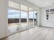 Bright room with light wood flooring and sliding glass doors leading to outdoor space at 19080 E 96Th Pl, Commerce City, CO 80022