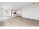 Spacious living room with modern wood floors and an open kitchen layout at 19080 E 96Th Pl, Commerce City, CO 80022