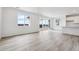 Bright living room features a sliding glass door, light wood floors, and a breakfast bar at 19080 E 96Th Pl, Commerce City, CO 80022