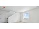 Bright room with staircase features a large window, white walls, and light wood floors at 19080 E 96Th Pl, Commerce City, CO 80022