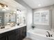 Double vanity bathroom with soaking tub and shower at 5833 Alton St, Denver, CO 80238