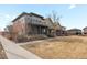 Two-story home with gray siding, landscaping, and a grassy yard at 5833 Alton St, Denver, CO 80238